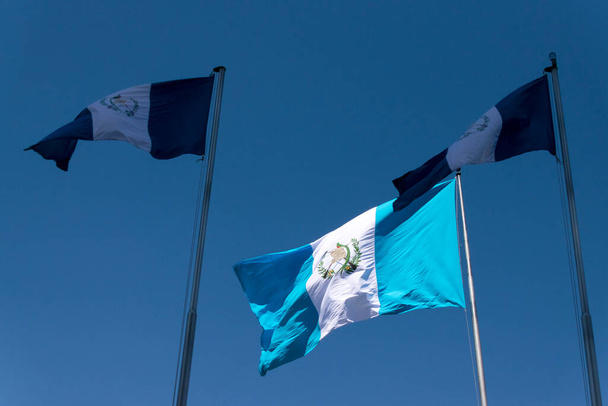 National flag of Guatemala, Central America, to the wind in antler, patriotic symbol, September 12, 1968 current version. Guatemala flag, national symbol, waving on the wind - Photo, Image