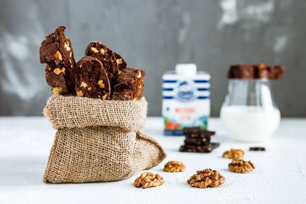 Homemade chocolate biscotti cookies with walnuts and a glass of milk  - Fotografie, Obrázek