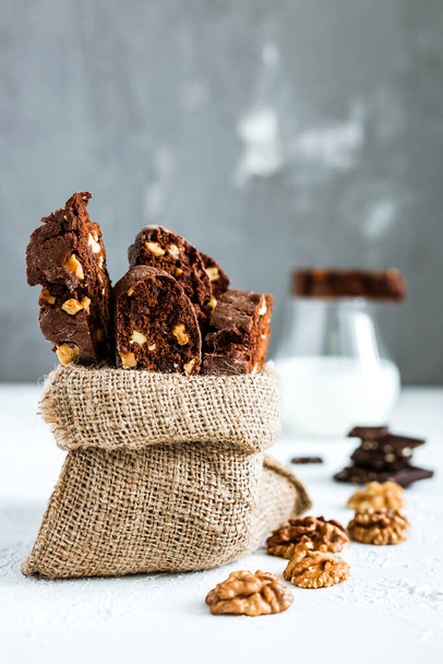 Homemade chocolate biscotti cookies with walnuts and a glass of milk  - Φωτογραφία, εικόνα
