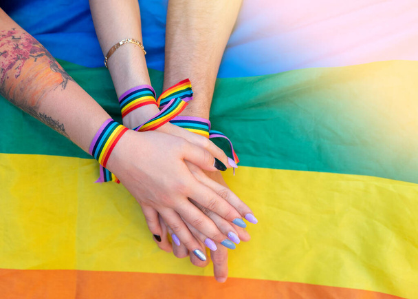 Detail of a group of hands with an lgtb flag - Photo, Image