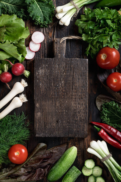 Fresh vegetables, herbs and nuts for cooking on dark wooden background, top view, place for text - Φωτογραφία, εικόνα