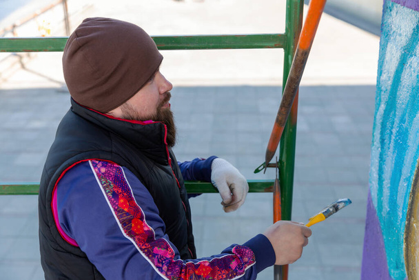 Graffiti artist painting street art with paint brush - Valokuva, kuva