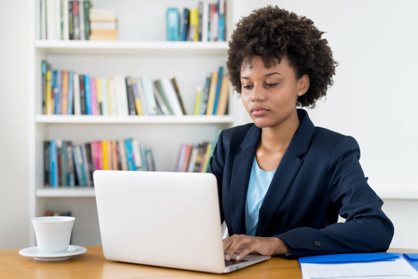 Beautiful african american business trainee working at computer indoors at home or at office - Photo, image