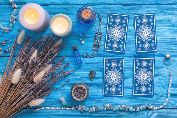 Blue tarot cards deck on blue wooden table flat lay background. - Photo, Image