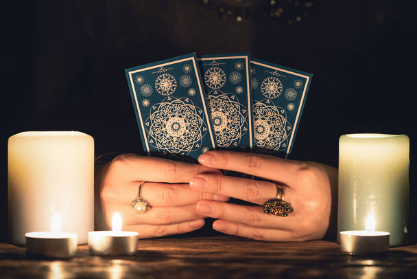 Fortune teller with tarot cards in hands close up. Future reading concept. - Foto, Imagem