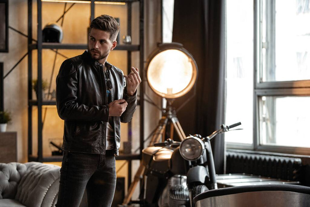 Perfect man. Young hipster in leather jacket standing in room. - Fotografie, Obrázek