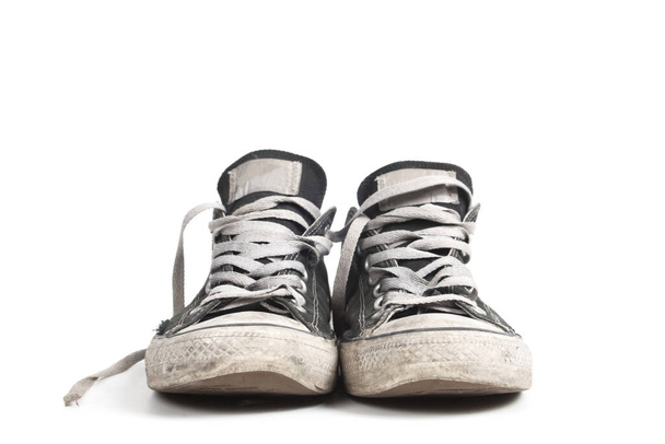 Old and dirty black canvas sneakers, isolated - Photo, Image