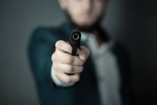 Man hand gun on dark background - Photo, Image