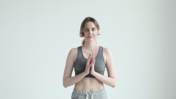 smiling girl in sportswear, holding hands in namaste gesture. health lifestyle - Záběry, video