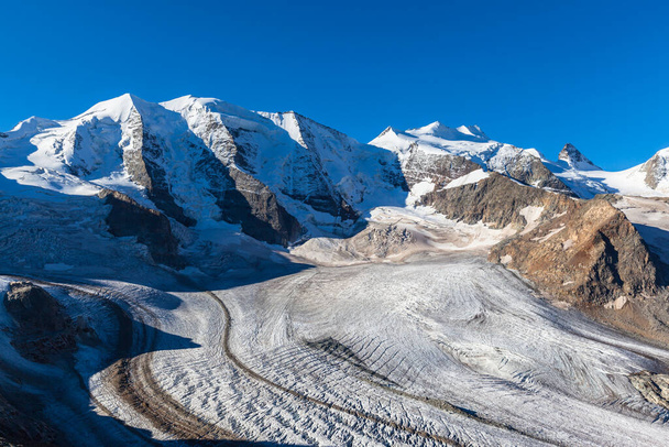 Stunning view of the Bernina massive including Piz Palu, Piz Bellavista, Piz Bernina and Morteratsch glacier at the mountain house Diavolezza in Engadin area of Switzerland. - Photo, Image