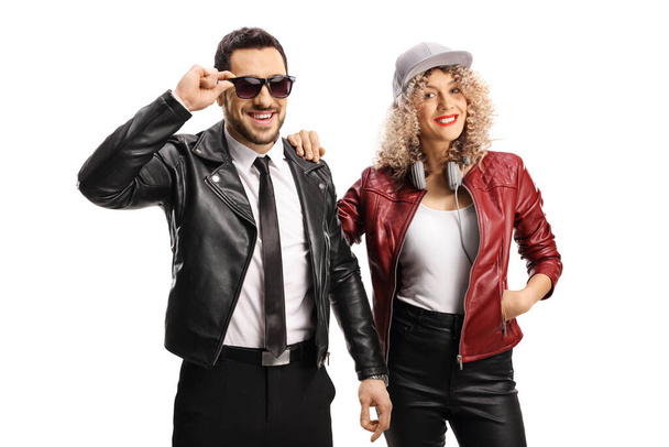 Young man with sunglasses with a young woman both wearing leather jackets isolated on white background - Φωτογραφία, εικόνα