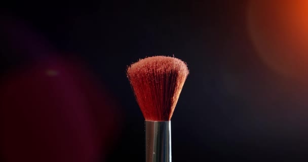 Two Make-up brush with powder on black background with sunlight Colour Paint Concept Slow Motion. - Кадры, видео