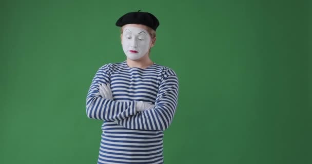 Impatient mime artist checking time while waiting over green background - Footage, Video
