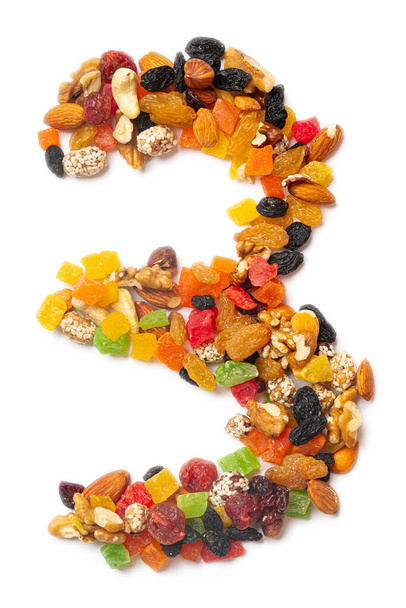 Arabic numeral "3"   from a mixture of hazelnuts, almonds, walnuts, cashews, seeds, raisins, candied fruit on a white isolated background. Food pattern made from nuts.  - Photo, Image