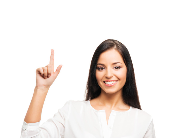 A young businesswoman pointing at something on white - Foto, Imagen