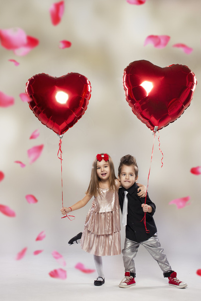 Happy kids with red heart balloon on a light background - Photo, image
