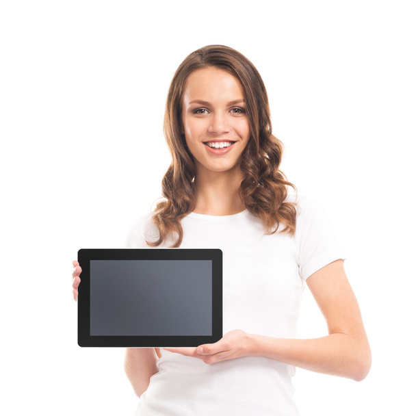 Portrait of a teenage girl holding a tablet computer on white - Zdjęcie, obraz