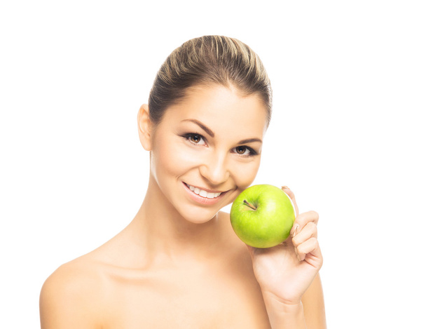 Portrait of a young naked woman holding an apple - Fotó, kép