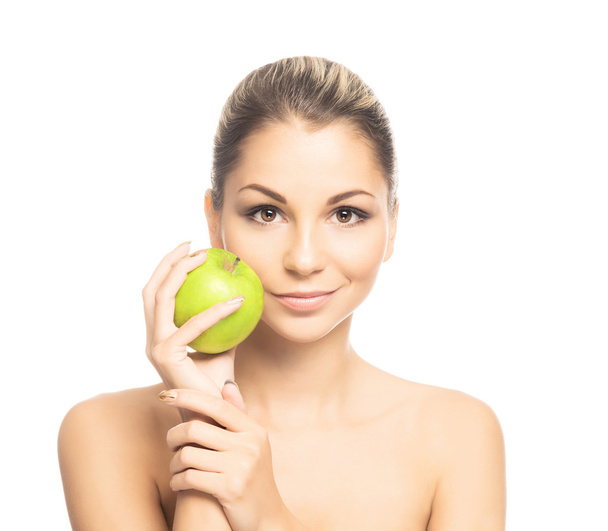 Portrait of a young naked woman holding an apple - Fotó, kép