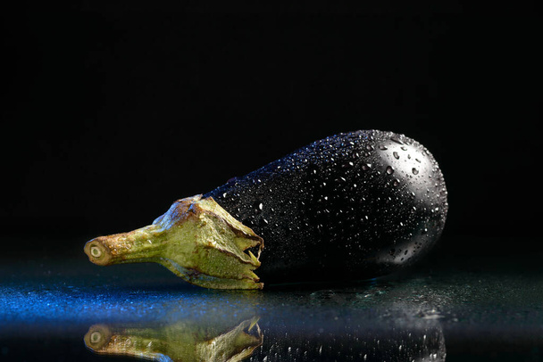 ne wet isolated eggplant with a reflection on a black background - Photo, Image