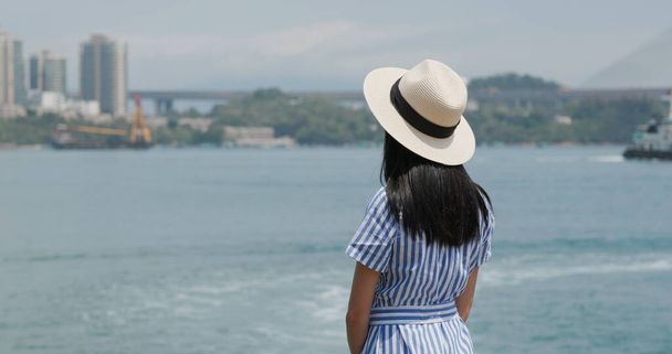 Cestovní žena se dívá na moře - Fotografie, Obrázek