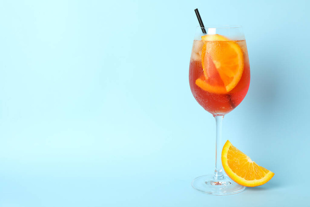 Aperol spritz cocktail on blue background. Summer drink - Фото, зображення