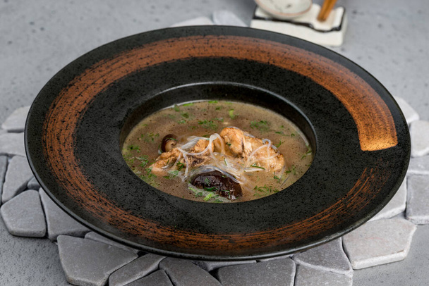 Mushroom soup in a deep brown plate - Фото, изображение