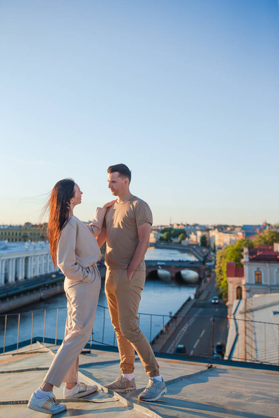 Family on rooftop enjoying with view of beautiful sunset in Sankt Petersburg in Russia - 写真・画像