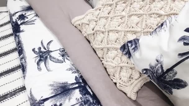 Beddengoed en kussens op kingsize bed met een tropisch motief als home decor in de slaapkamer, luxe interieur en meubilair - Video