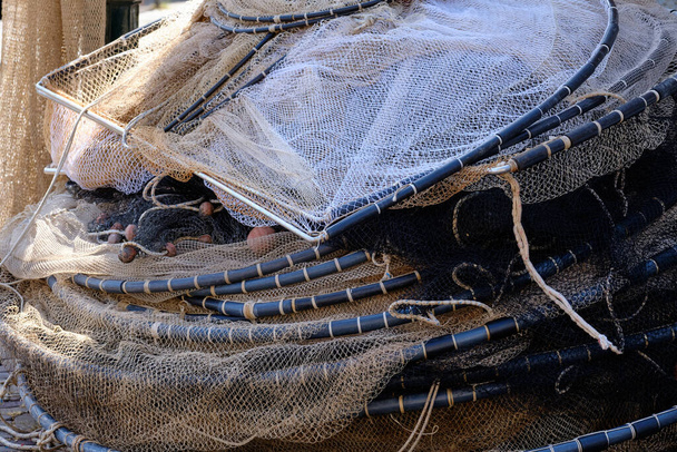 Many Fishing Nets And Floats, Stacked On A Wooden Dock. Stock