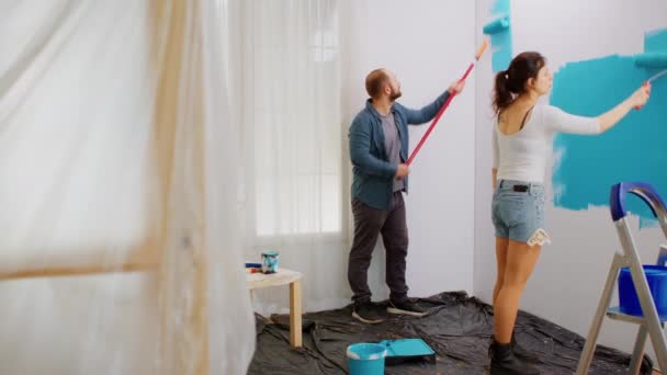 Couple painting wall with roller - Footage, Video