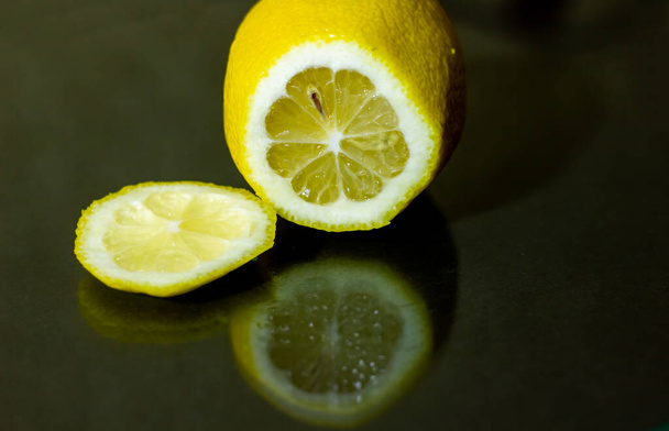 slice of juicy lemone on black background - 写真・画像