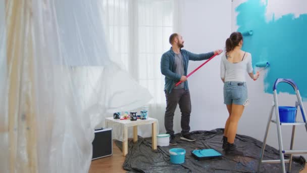 Муж и жена рисуют стену - Кадры, видео