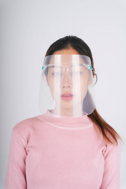 New normal fashion portrait. Asian thai long dark hair woman wearing face shield isolate over white. - Foto, Imagem