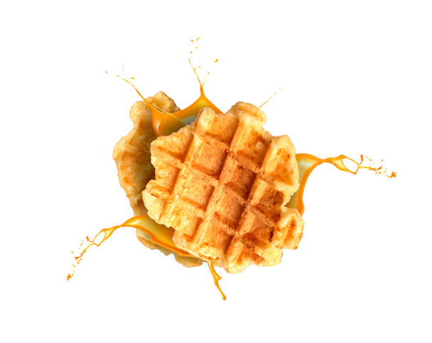 falling two waffles and caramel splash isolated - Foto, afbeelding