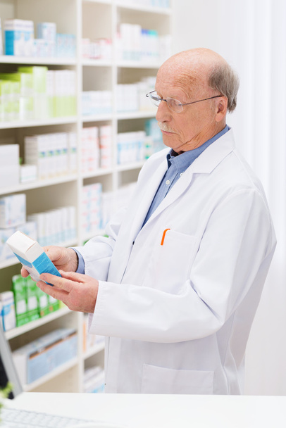 Senior pharmacist checking his stock - Fotoğraf, Görsel