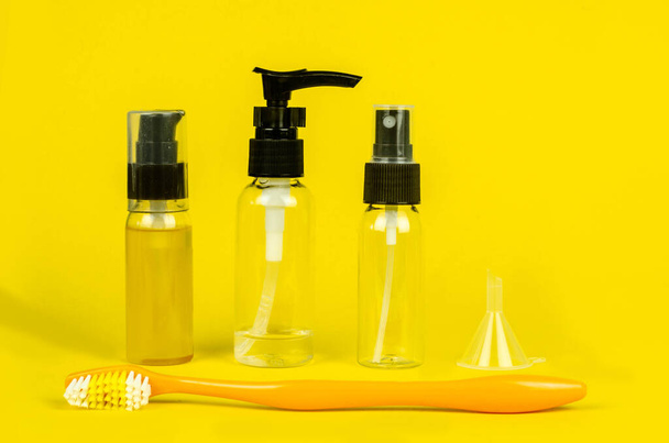 Набор прозрачных пластиковых бутылок для туалетных жидкостей и зубной щетки для упаковки в дорогу
 - Фото, изображение