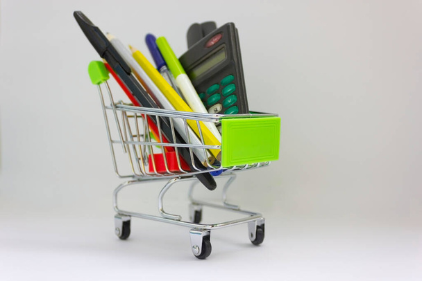School market. Purchase in supermarket. School supplies concept. Shopping basket with pencils paints and apple fruit close up. Back to school.stationery. preparing for school by September 1. - Photo, Image
