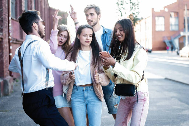 Happy friends having fun walking on city street center outdoor - Young millennials people dancing together - Zdjęcie, obraz