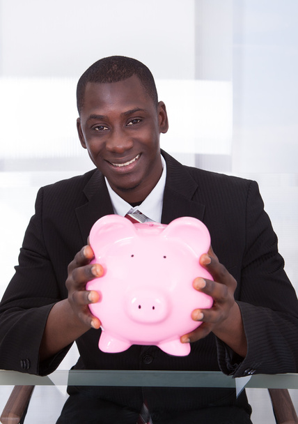 Businessman Holding Piggybank - Photo, image
