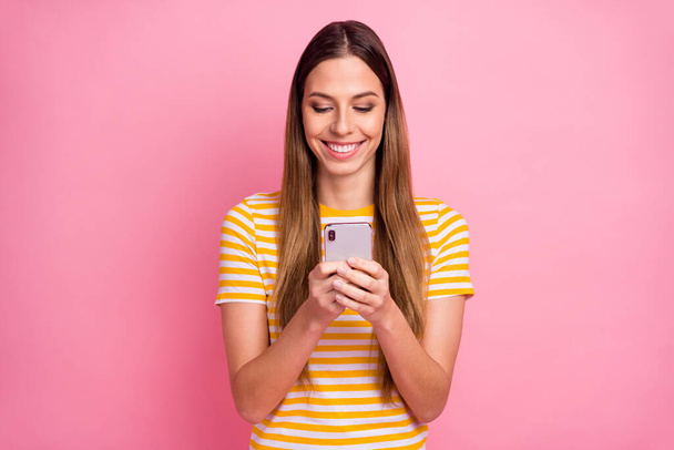 Close-up portrait of her she nice attractive lovely pretty charming cheerful cheery focused girl sending sms using digital 5g isolated over pink pastel color background - 写真・画像