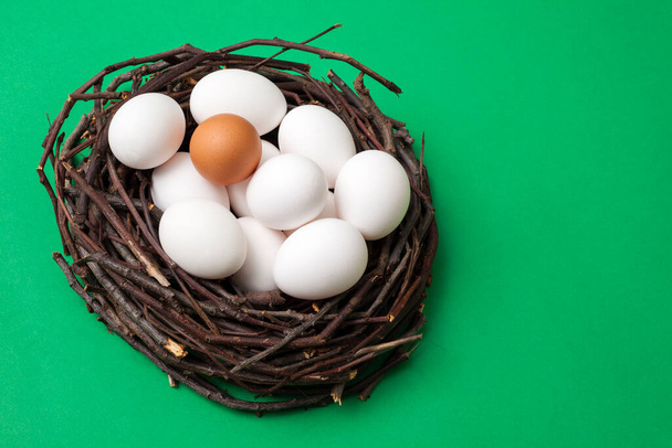 Bird nest with eggs isolated on green box background, top view, for copy space and product placement. - Φωτογραφία, εικόνα