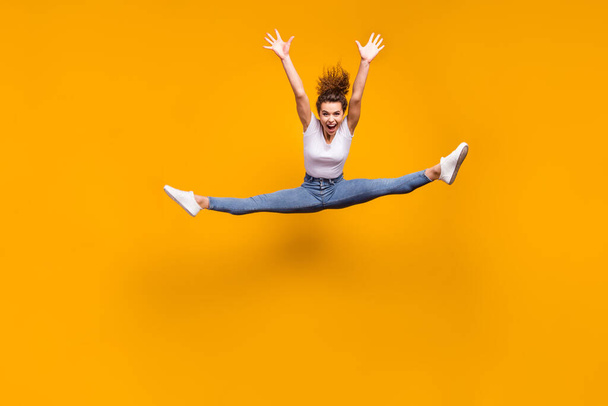 Full length body size view of her she nice attractive sporty slender crazy cheerful girl jumping dancing doing exercise twine isolated on bright vivid shine vibrant yellow color background - Fotografie, Obrázek