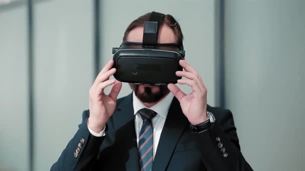 Businessman making fun with VR glasses standing outdoors on the street playing with cover of it. Modern technologies in business. Business concept. Cold tone. Prores 422 - Video
