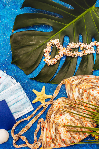 Travel and vacation coronavirus concept. Summer 2020 background with medical mask, passports, beachwear, marine symbols and jewelry. Nautical background - Φωτογραφία, εικόνα