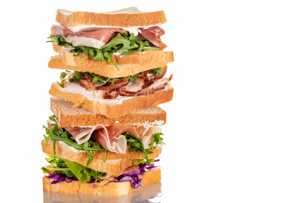 fresh sandwiches with arugula and meat on white surface - Фото, изображение