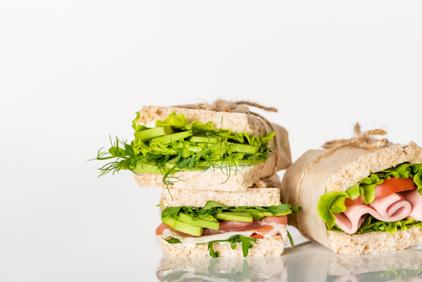 fresh green sandwiches with avocado and meat on white surface - Foto, immagini