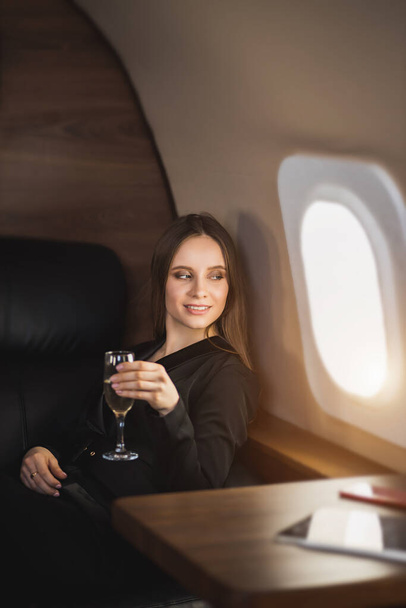 Attractive woman in private jet - Фото, зображення