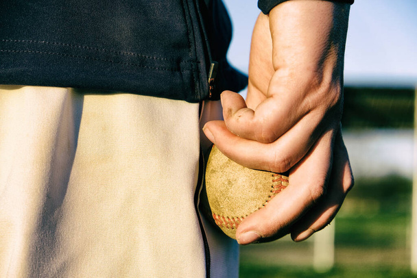 Baseball athlete lifestyle with ball close up in hand for pitcher concept - Photo, Image