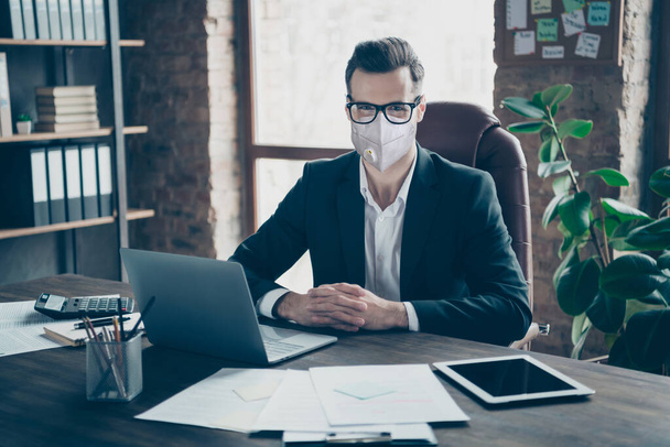 Portrait of his he of nice executive employee guy top hr attending interview sitting chair wearing n95 safety mask stop mers cov influenza at modern industrial loft work place station - Фото, зображення